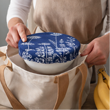 blue patterned lids on white bowls in various settings.