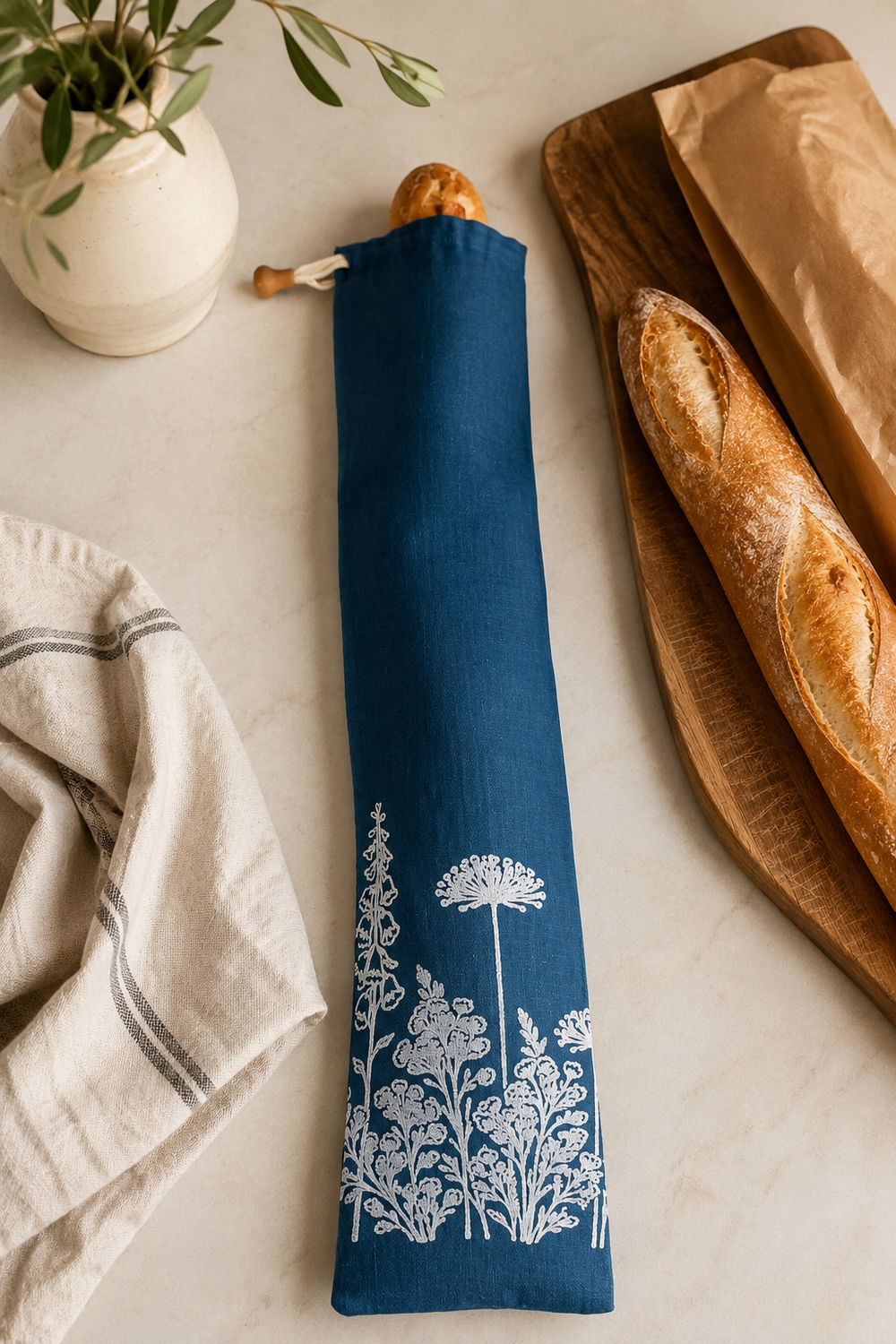 Navy linen baguette bag with white Florilegium floral print, hand printed in Derbyshire for storing French sticks and artisan baguettes.