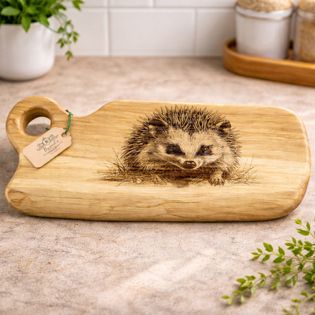 Wooden cutting board with a hedgehog design on a kitchen counter.