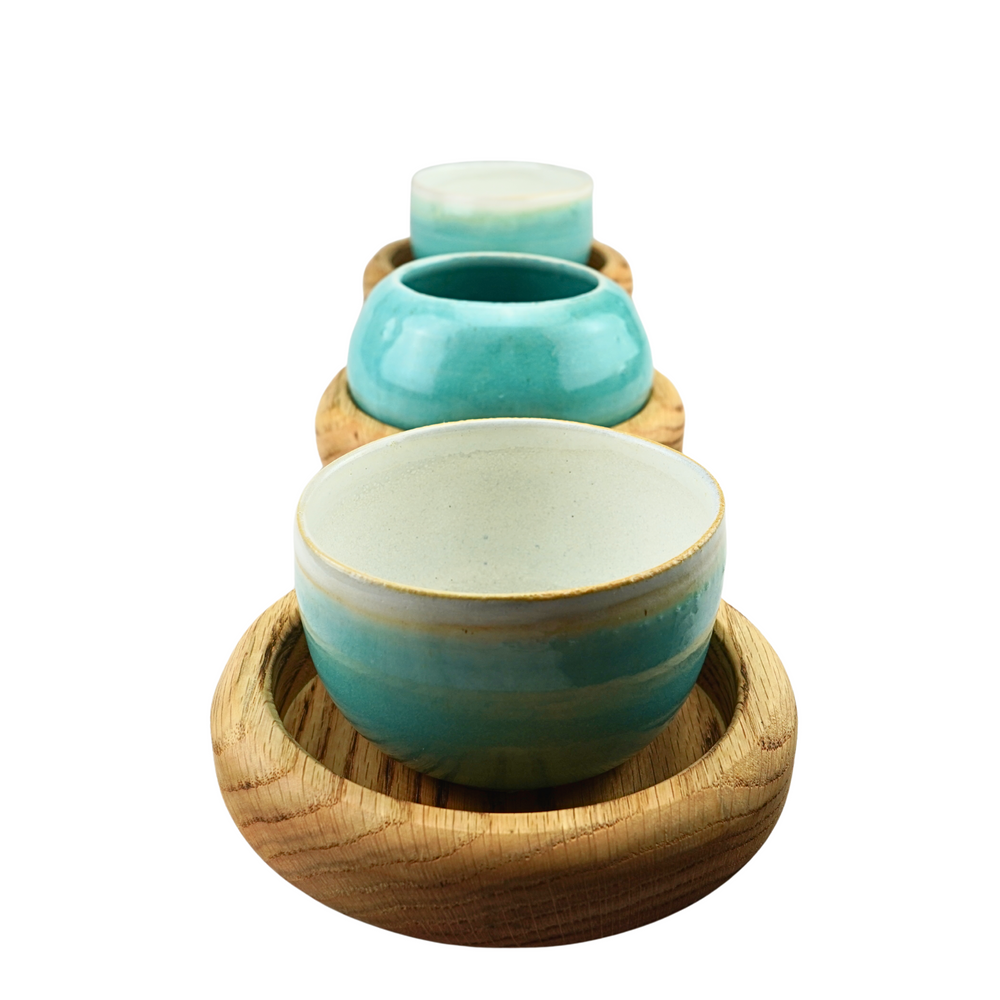 Oak table centrepiece serving board with three stoneware bowls
