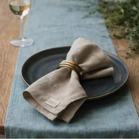 Ocean Mint Linen Table Runner on dining table setting with food and tableware.