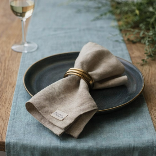 Ocean Mint Linen Table Runner on dining table setting with food and tableware.