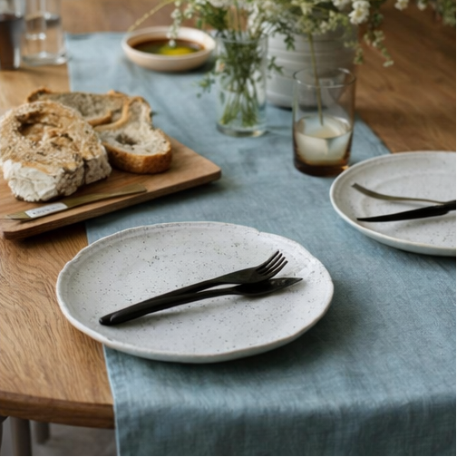 Ocean Mint Linen Table Runner on a dining table setting with food and tableware.