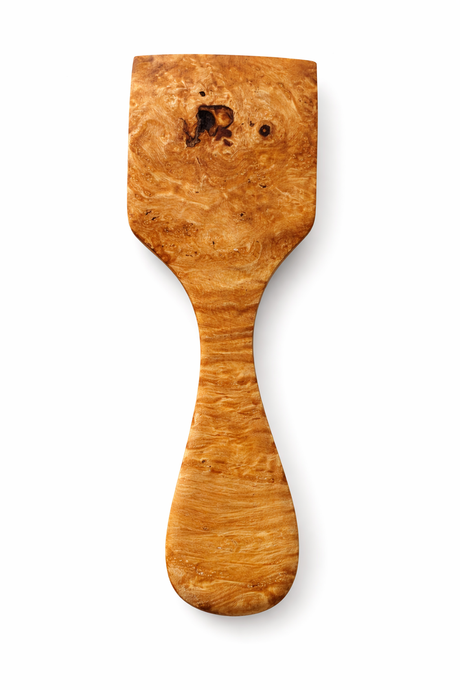 Wooden spatula with a burl pattern on a white background