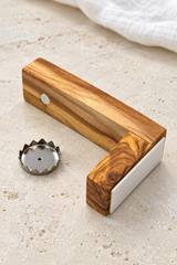 Olive wood magnetic soap holder with the soap disc removed to reveal the round magnet beneath the arm.