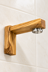 Olive wood magnetic soap holder with the soap disc removed to reveal the round magnet beneath the arm.