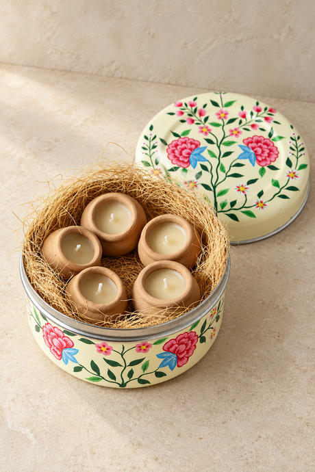 Five little terracotta candles and a hand-painted tin to keep. This candle gift set combines lavender with a subtle hint of vanilla, with approximately three hours of burn time per candle. Once emptied, the white stainless steel container can hold biscuits or small keepsakes.