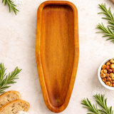 Wooden tray on a light surface with rosemary and chickpeas
