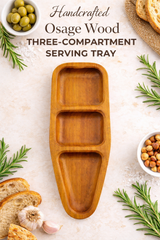 Wooden three-compartment serving tray with food items on a light background
