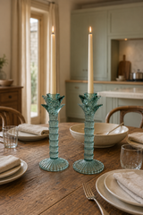 Pair of green glass palm tree candlestick holders with ribbed stems and fluted round bases