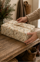 Partridges hold golden stars while tiny mice climb ladders and decorate pear trees with baubles, ribbon and gifts. A detailed pencil-sketch Christmas wrapping paper inspired by a familiar festive favourite.