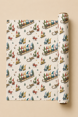 Personalised Christmas wrapping paper featuring seven customer-supplied faces on colourful gonks racing downhill on a wooden sledge, with seven corresponding names printed along the side. The pencil-sketch pattern also includes gonks hauling sledges, carrying fir trees and tumbling through snow, with gold stars, small trees and sledge tracks on warm ivory.