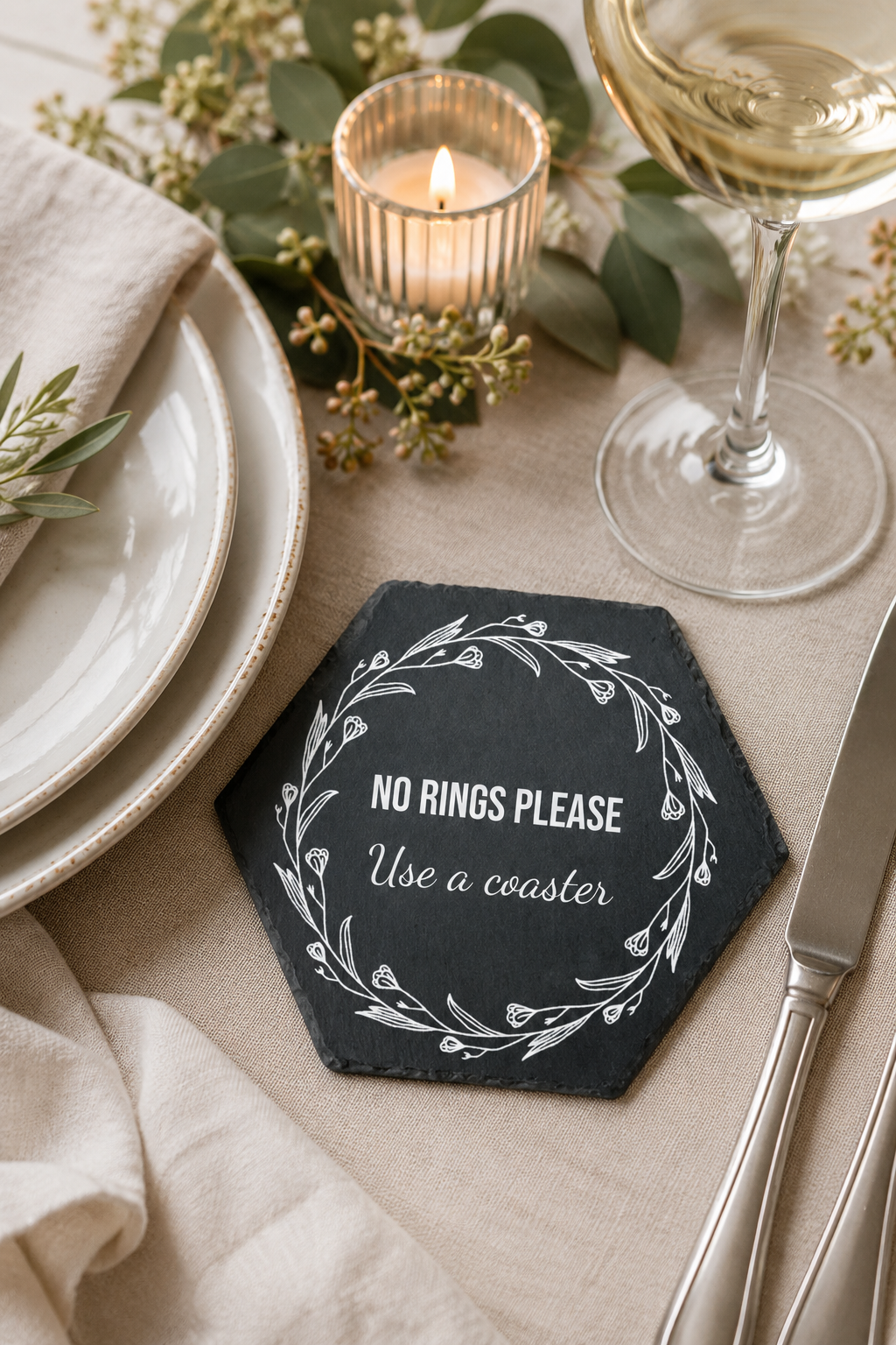 Personalised hexagonal slate drinks coaster engraved with wording, made from natural slate with rustic edges.