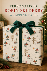 Bobble-hatted robins ski, snowboard and tumble down a snowy course while three wooden signposts display six names or short messages chosen by you. Personalised Christmas gift wrap for families and winter-sports fans.