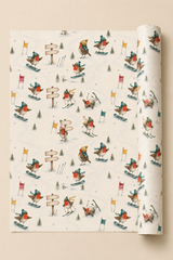 Personalised Christmas wrapping paper featuring robins skiing, snowboarding and racing through snow. Three wooden signposts each contain two personalised signs, providing six spaces for names or short messages.