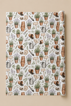 A roll of Personalised Terracotta Pot  wrapping paper featuring a repeating botanical and gardening pattern with potted plants, watering cans, trowels, wooden signs, and lavender sprigs on a white background, shown against a warm beige backdrop.