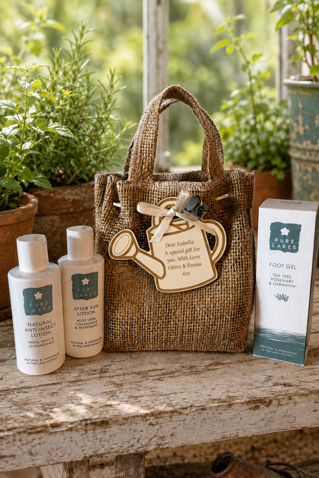A mini hessian tote bag with a personalised wooden watering can charm sits on a rustic stone surface