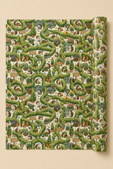A roll of wrapping paper featuring a hedgehogs in a garden maze of hedges pattern, with signs that can be personalised with text. Shown partially unrolled against a solid beige background.