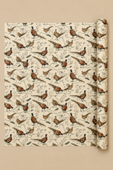 Cock and hen pheasants strut, flap and stumble through colourful fairy lights among winter grasses, berries and pine sprigs. A pencil-sketch Christmas wrapping paper with proper British countryside character.