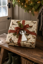 White filigree angel gift tag tied to a present wrapped in Pheasant Tangled in Fairy Lights Christmas paper.