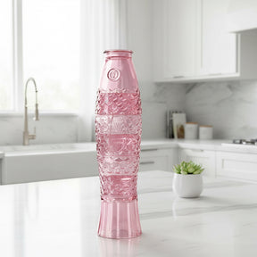 Pink stacking glass's that make a fish when stacked set in a kitchen