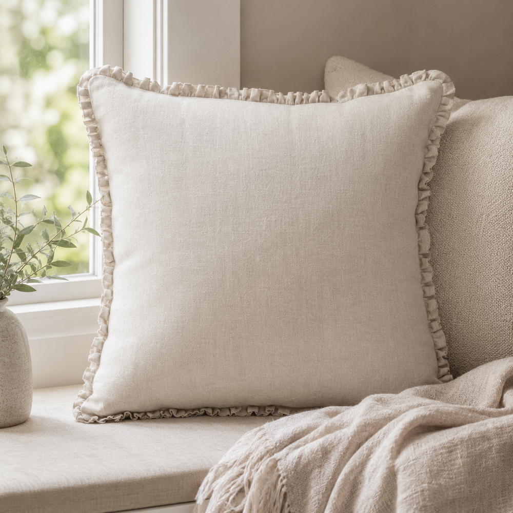 Plain natural linen cushion cover with ruffle edge styled on a window seat.