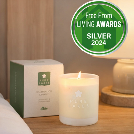 Pure Lakes candles with packaging and a silver award badge.