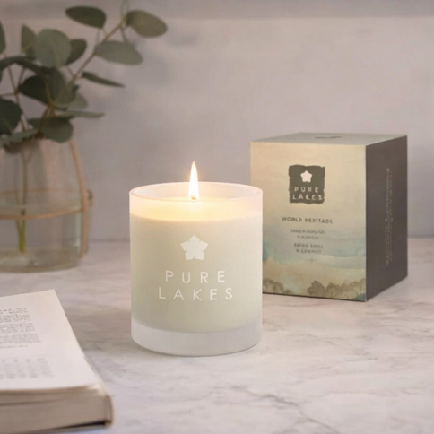 Pure Lakes candles with packaging and decorative elements.