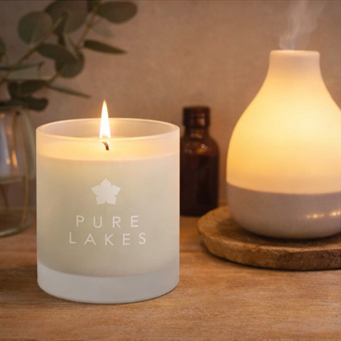 Pure Lakes candles with packaging and decorative elements.