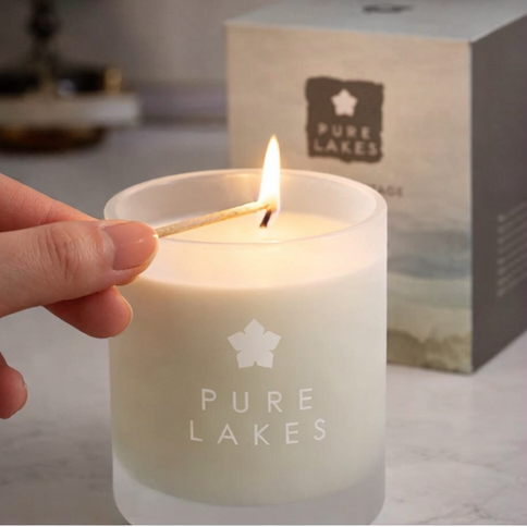 Pure Lakes candles with packaging and decorative elements.