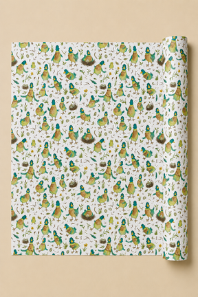 A roll of wrapping paper with a dense pattern of illustrated birds in green, yellow, and brown on an off-white background, shown against a solid beige backdrop.