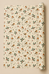 Red-breasted robins perch among glossy holly, rosehips, winter twigs and golden stars in this traditional illustrated Christmas wrapping paper on a warm cream ground.