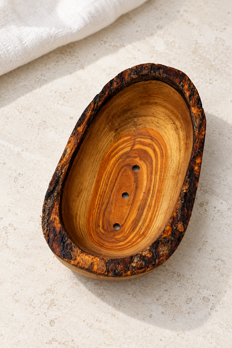 Warm olive wood grain, a rustic bark edge and a simple oval shape bring natural texture to the bathroom basin. This handmade soap dish has three drainage holes and an underside groove