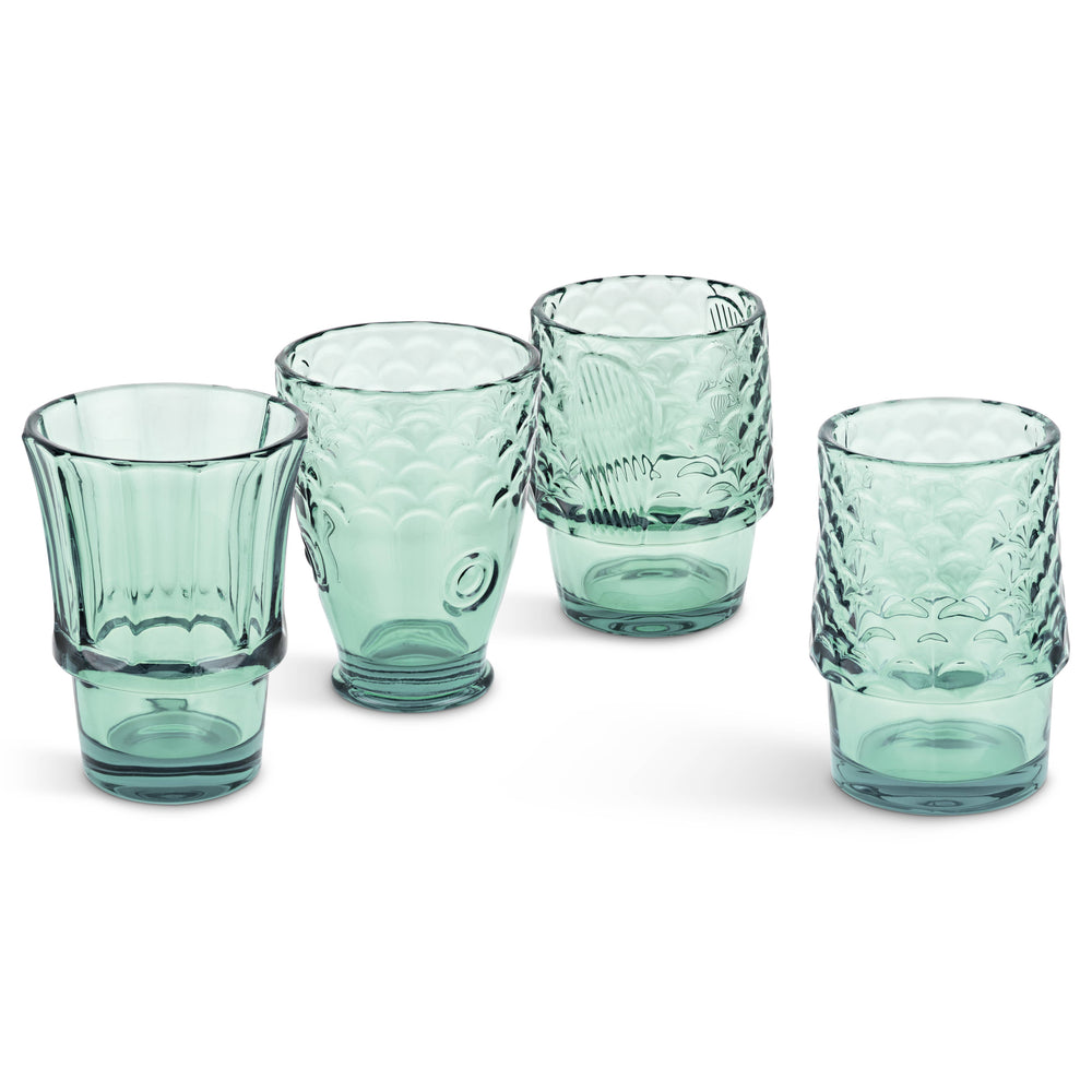 Set of four green glass tumblers with textured design that makes a fish when stacked on a white background
