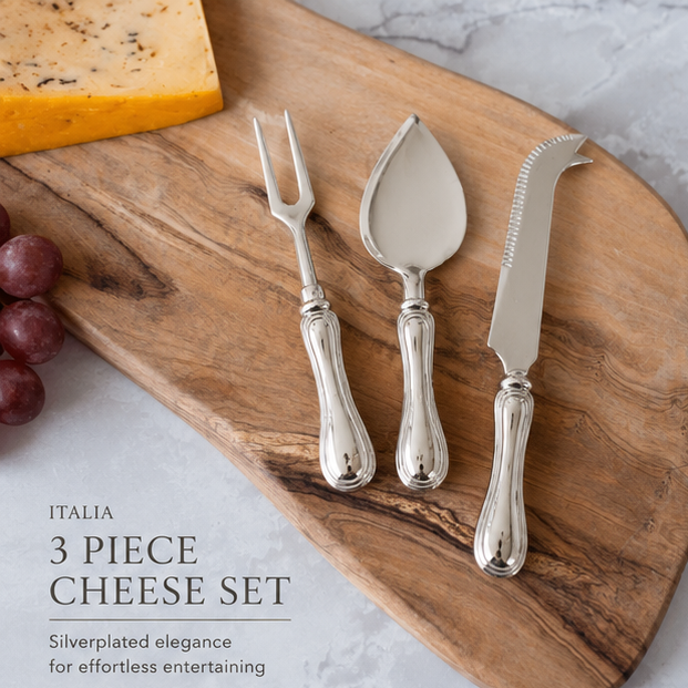 Silver cheese knife, server, and fork set on a wooden board with cheese and grapes.