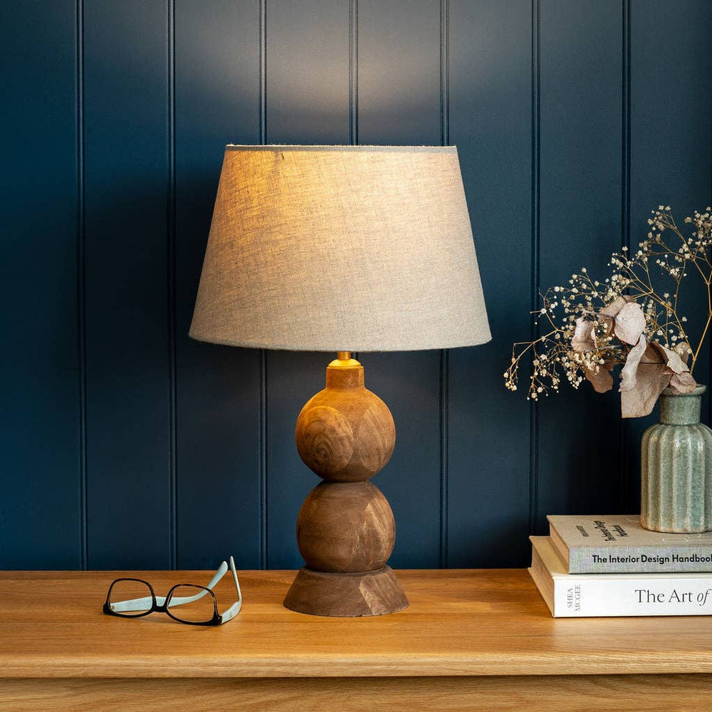 Smooth farmhouse brown finish and visible grain on the hand-carved Frampton lamp base