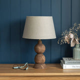 Smooth farmhouse brown finish and visible grain on the hand-carved Frampton lamp base