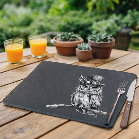Slate placemats with owl design on  a table outside  