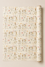 A roll of wrapping paper with a repeating pattern of Fashion Girls figures in pastel pink, beige, and grey on an off-white background, shown partially unrolled.