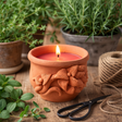 terracotta rose candle with herbs in a warm and cozy atmosphere.
