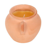 Terracotta pot with a candle inside on a white background