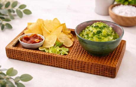 Tray with chips, guacamole, and salsa on a white surface
