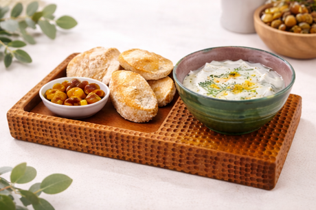 snack platter with bowls of food on a white background.