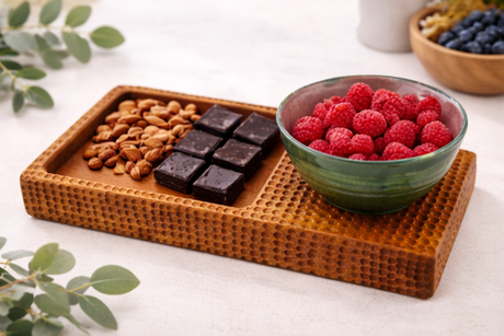snack platter with bowls of food on a white background.