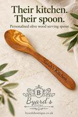 Byard’s Boutique pin featuring an engraved olive wood serving spoon, the headline “Their kitchen. Their spoon.”, the boutique logo and website address.