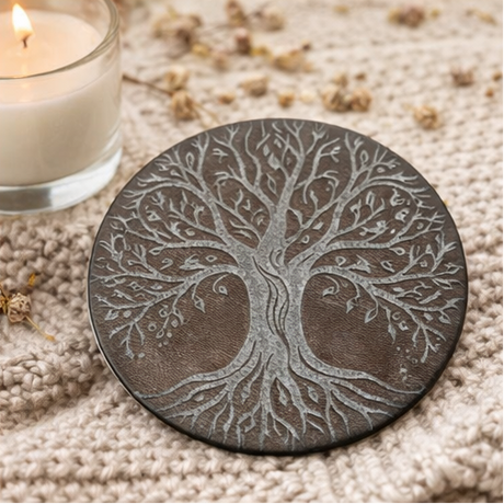 Set of four tree-patterned leather coasters with different backgrounds