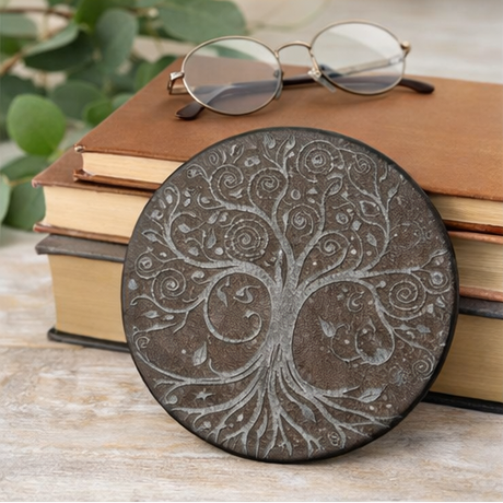 Set of four tree-patterned leather coasters with different backgrounds