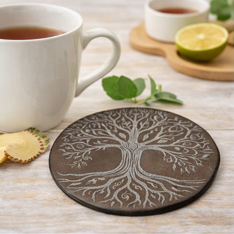 Set of four tree-patterned leather coasters with different backgrounds