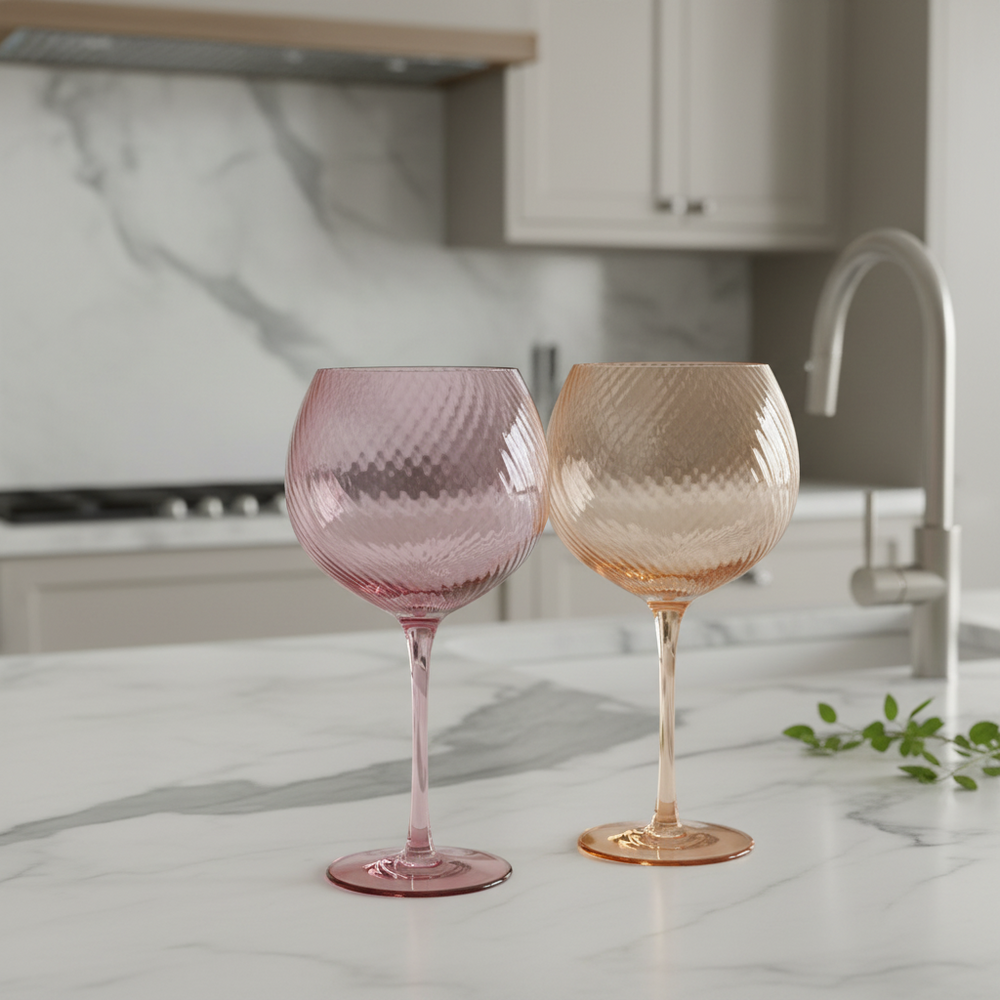 Two colourful wine glasses, one pink and one peach.