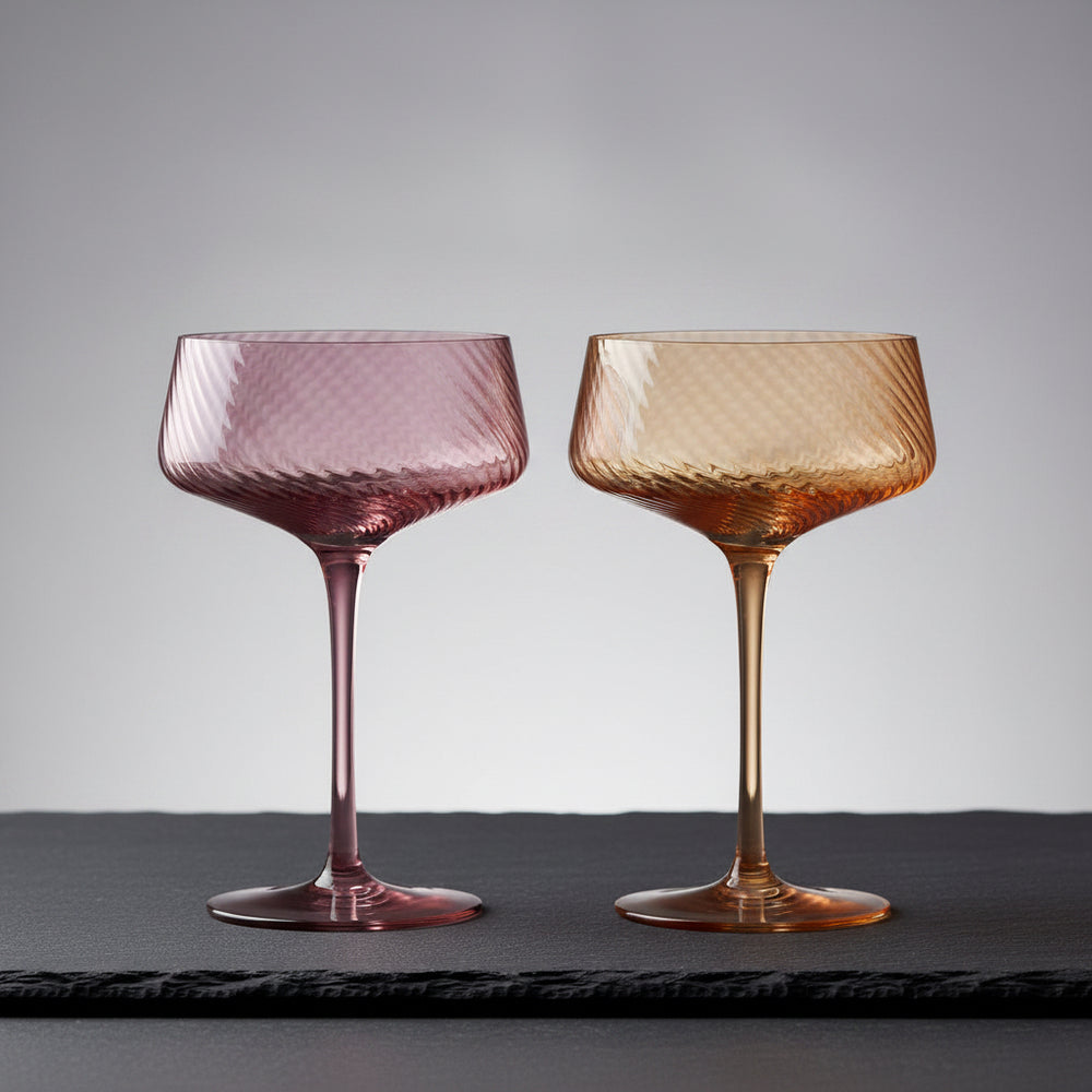 Two pink and peach-colored glass goblets 
